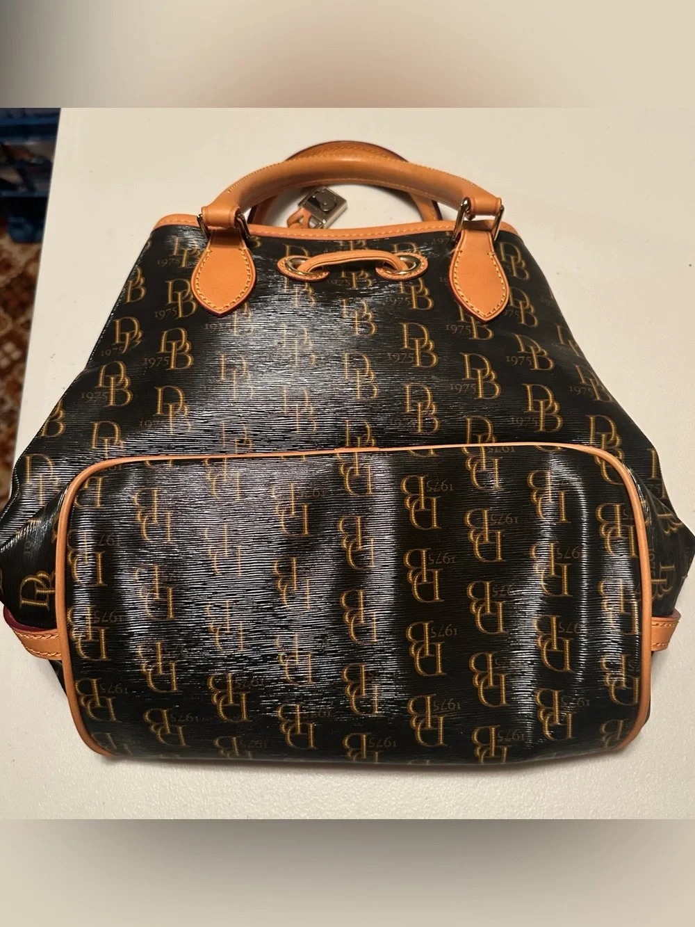 Dooney & Bourke signature brown 1975 DB logo coated canvas bucket bag